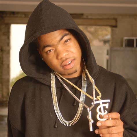 A man in black hoodie holding a pair of silver chains.